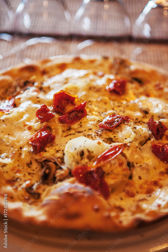 Close-up of pizza served on a plate in an Italian restaurant Close-up of pizza served on a plate in an Italian restaurant