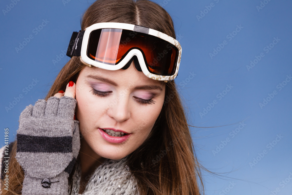 skier girl wearing warm clothes ski googles portrait.