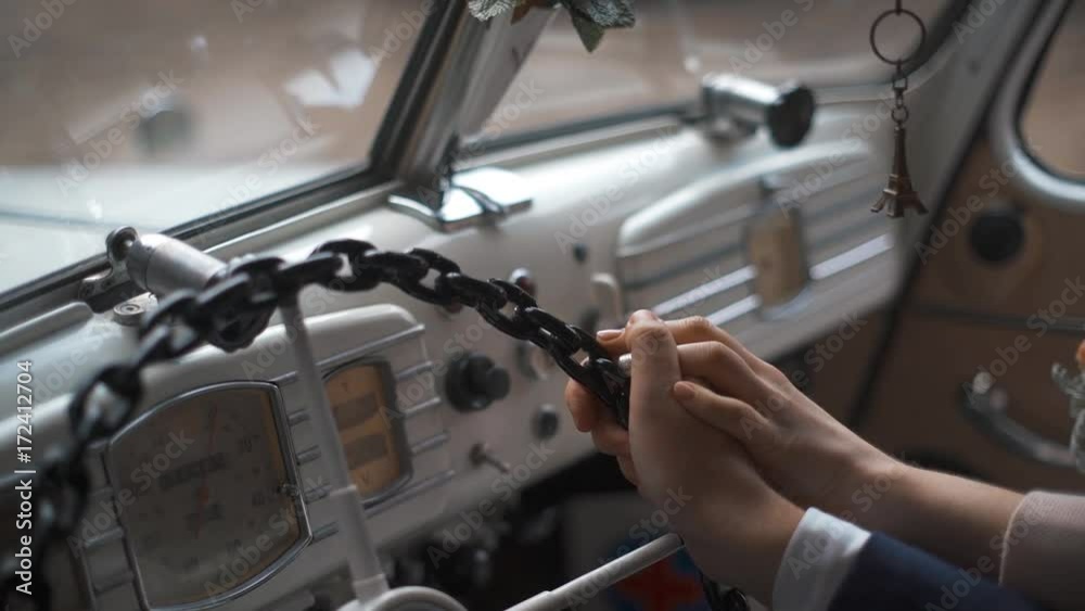 Young wedding couple hands on steering wheel of retro car. No faces. Young wedding couple hands on steering wheel of retro car. No faces.