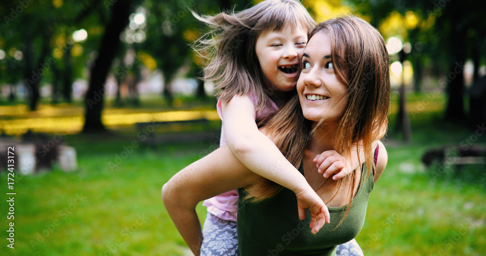 Little girl with special needs enjoy spending time with mother Little girl with special needs enjoy spending time with mother