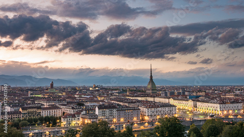Torino Cityscape, Italia. Skyline panoramic view of Turin, Italy, at dusk with glowing city lights. The Mole Antonelliana illuminated, scenic effect. © fabio lamanna