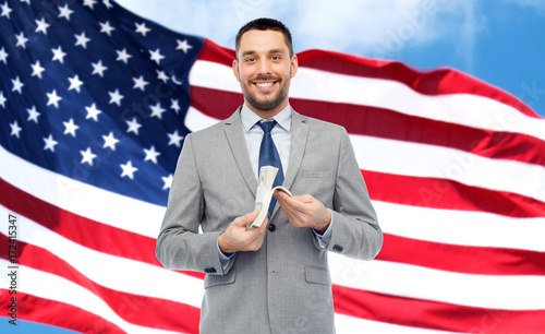 smiling businessman with american dollar money