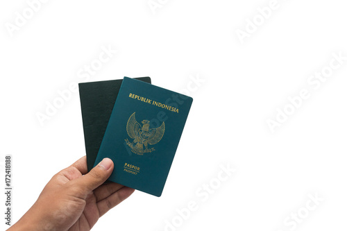 travel concept - hand with passport isolated on white background. Indonesia passport.