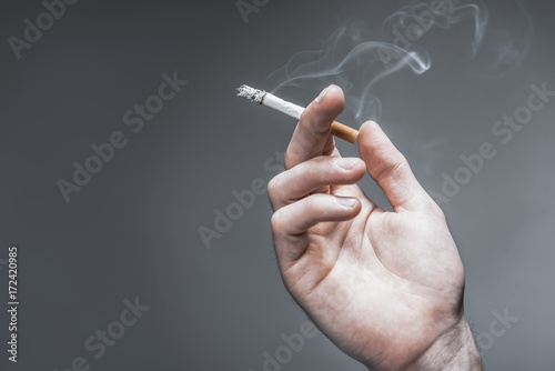 Arm of young man smoking photo