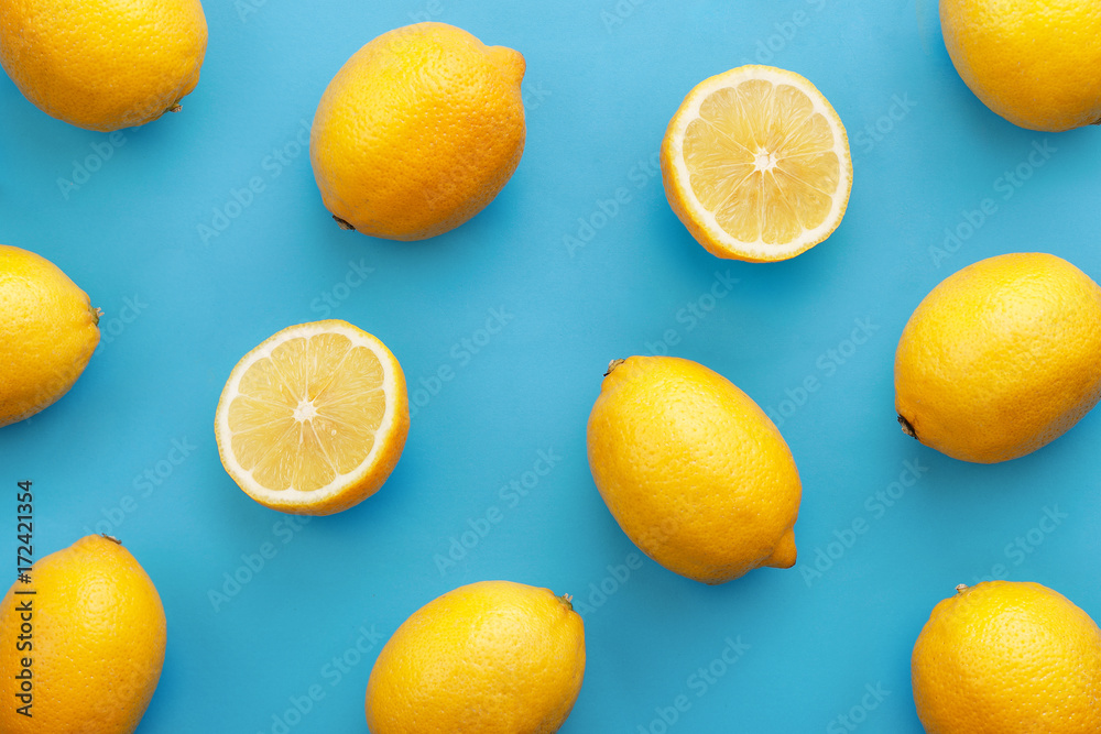 Lemon fruit pattern on turquise background. Repetition concept. Top view