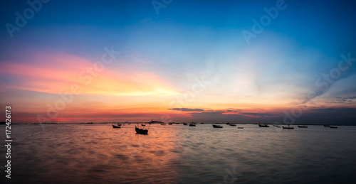 silhouette fishing boats on the sea during twilight sky