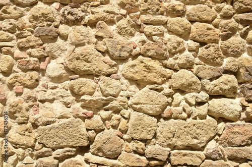 Background of stone wall in the medieval village of Pals, Girona, Spain