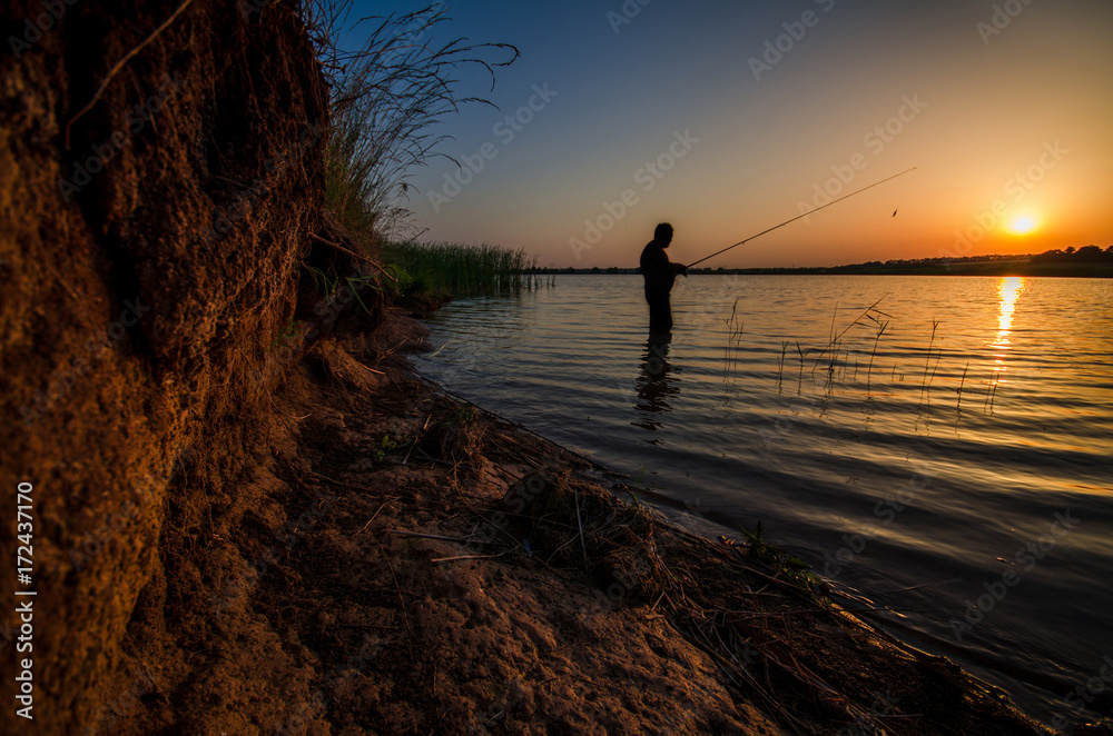 man is fishing on a lake