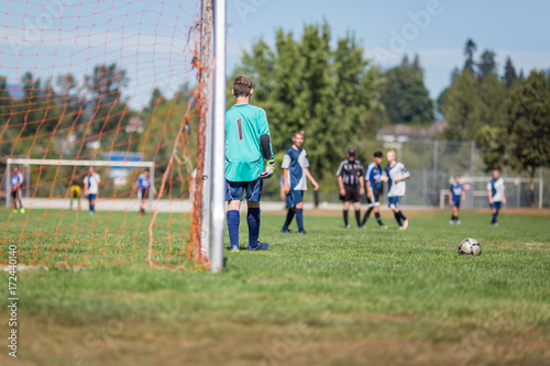 Young soccer goalkeeper in preparation for a goal kick