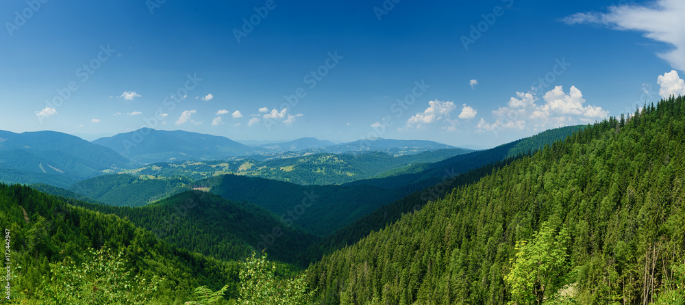 Carpathian mountains summer landscape with blue sky and clouds, natural background. Panoramic view