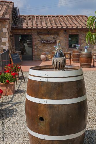 Brown wooden wine barrel beside the wine shop entry, Chianti region, Tuscany, Italy © Arkadii Shandarov