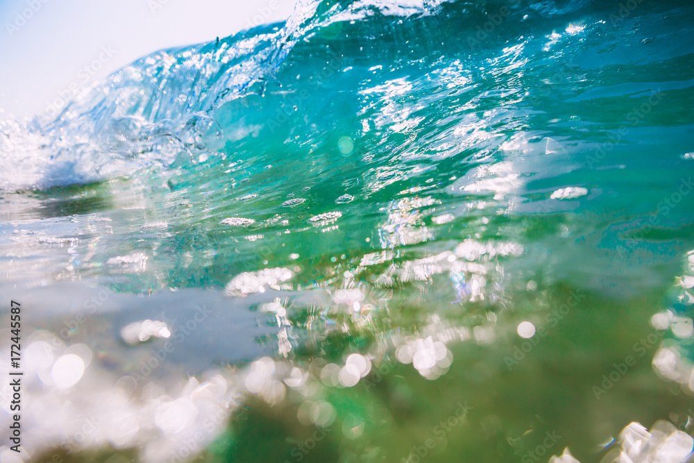 Fototapeta premium Blue wave in ocean. Clear wave and bokeh