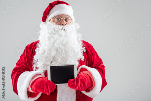 Santa Claus showing tablet