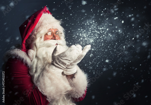Santa Claus blowing magic snow of his hands © Tijana