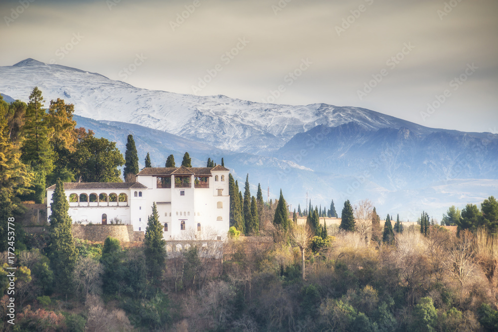View of the Generalife of Alhambra against the background of Sierra Nevada mountains, Granada, Andalusia, Spain