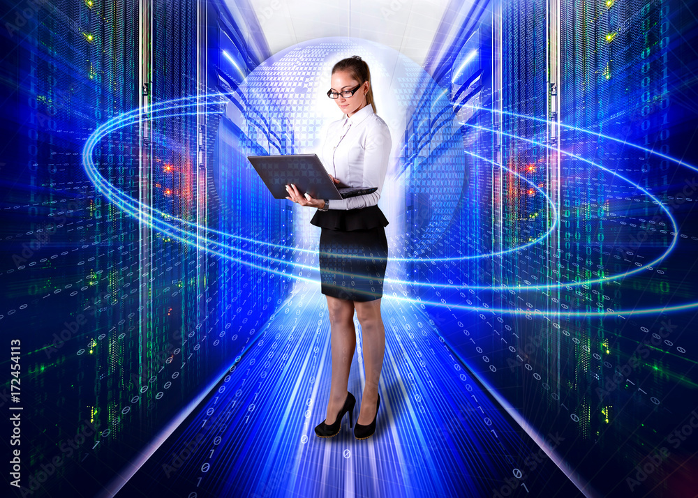 young lady engineer in office clothes standing with laptop in hands on background the server room of data center and futuristic design of concept big data young lady engineer in office clothes standing with laptop in hands on background the server room of data center and futuristic design of concept big data
