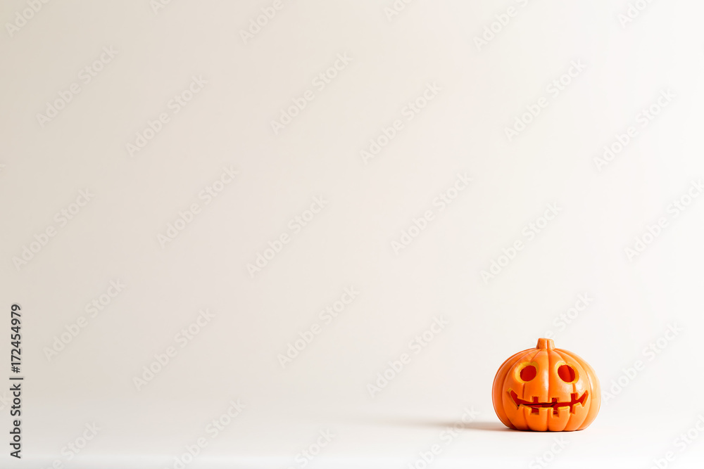 Fototapeta premium Halloween pumpkin ornament on an off white background