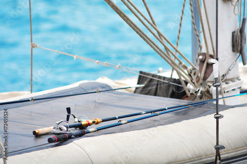 Fishing rods on a yacht board. Sea fishing in clear sunny weather. 