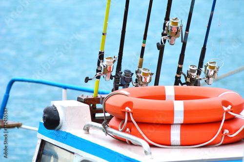  Fishing rods and lifebuoys on a yacht. Preparing to the sea fishing. 