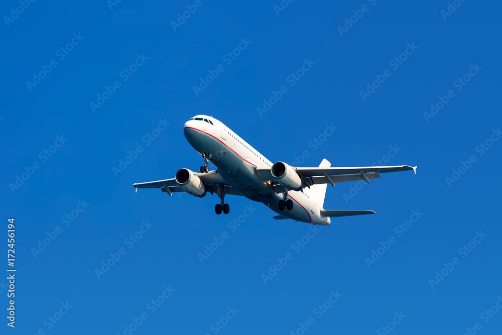Fototapeta premium Airplane on a blue sky background