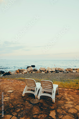 Colorful wooden beach chairs with sun umbrella © nazariykarkhut