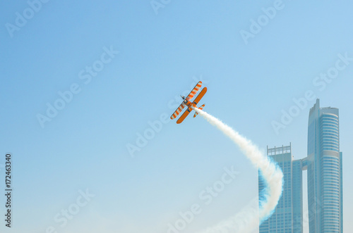 A man doing acrobatic figures over a plane, aircraft race, Abu Dhabi, UAE