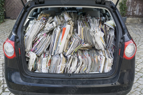 cardboard and paper piled in a car, ready to recycle