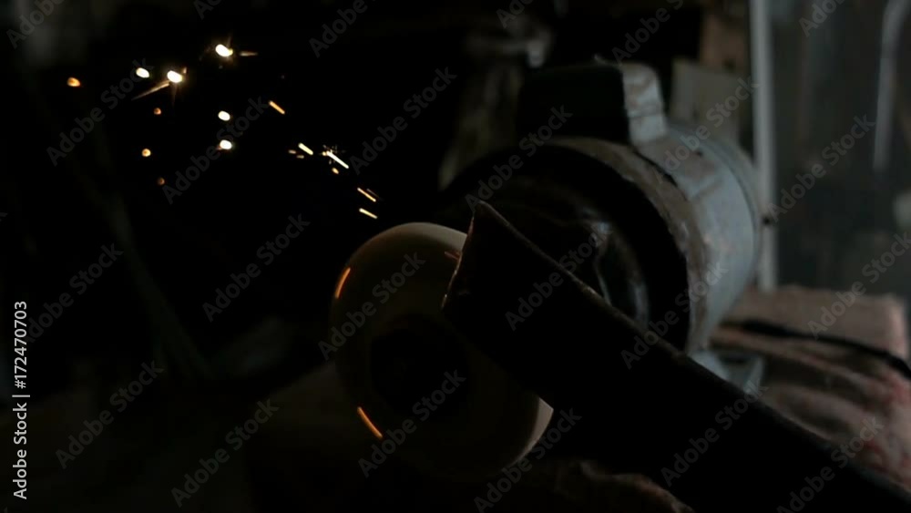 The worker sharpens the tool. Work on a sharpening machine.