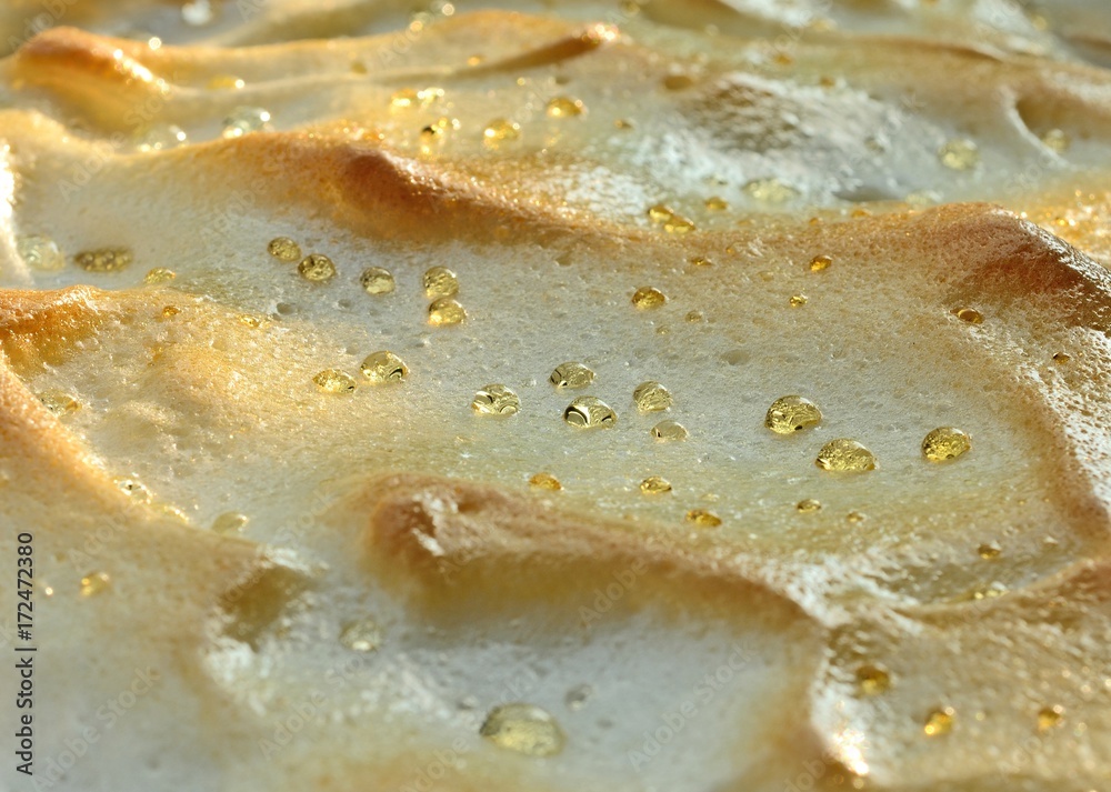Droplets of syrup on surface of meringue on cake Droplets of syrup on surface of meringue on cake
