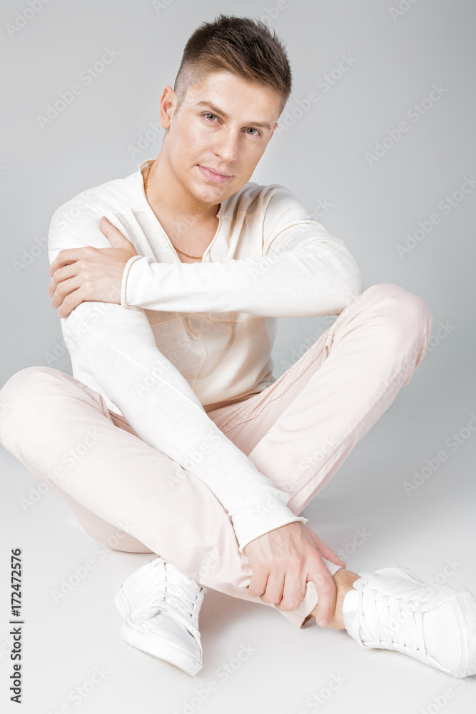 handsome young man in a white sweater handsome young man in a white sweater