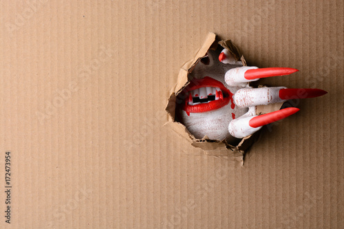 Vampire tearing through cardboard with sharp claws