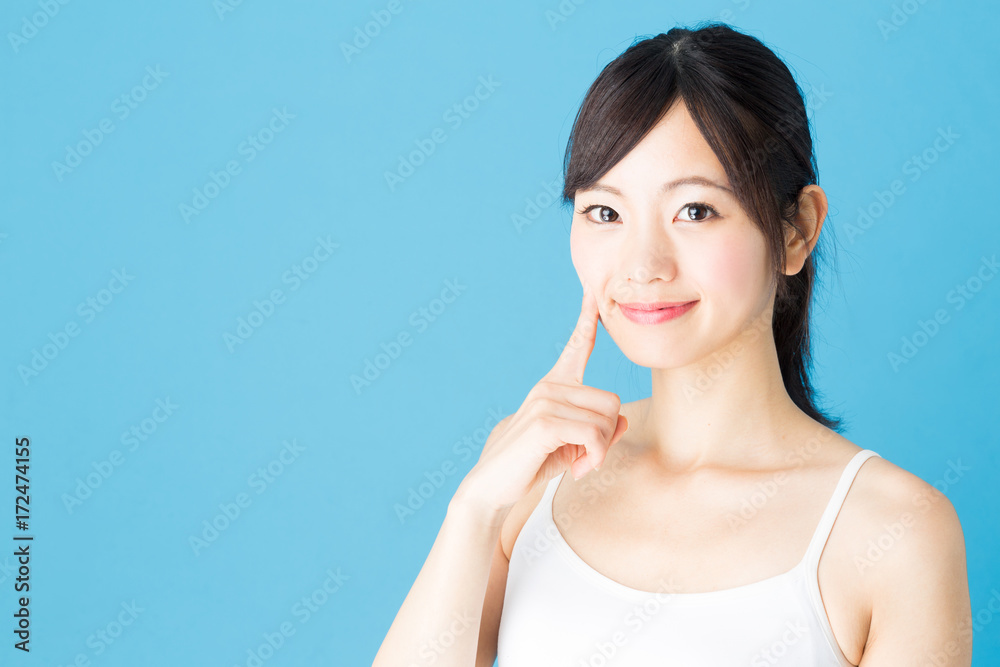 attractive asian woman beauty image isolated on blue background attractive asian woman beauty image isolated on blue background
