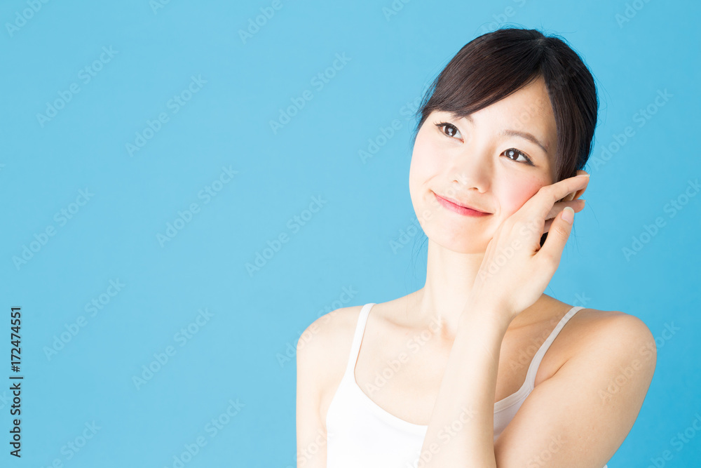 attractive asian woman beauty image isolated on blue background attractive asian woman beauty image isolated on blue background
