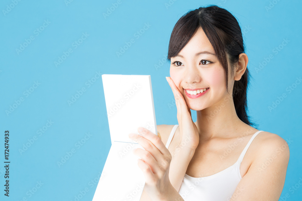 attractive asian woman beauty image isolated on blue background attractive asian woman beauty image isolated on blue background