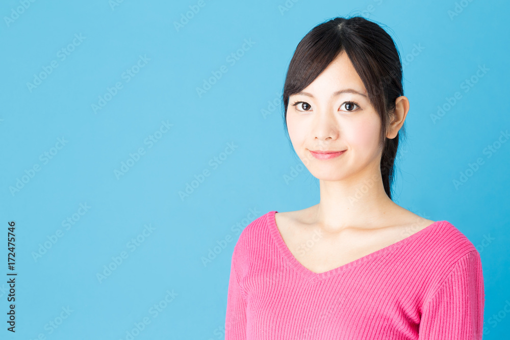 portrait of young asian woman isolated on blue background portrait of young asian woman isolated on blue background