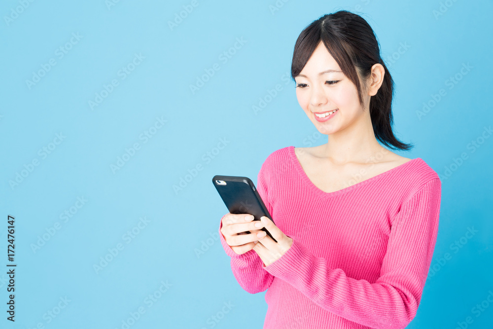 portrait of young asian woman isolated on blue background portrait of young asian woman isolated on blue background