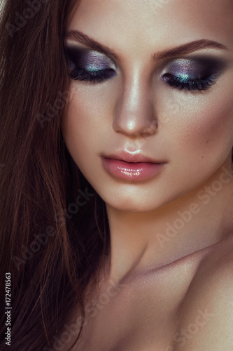 Beauty Woman Face. Closeup Of Beautiful Young Female Model With Soft Smooth Skin And Professional Facial Makeup.