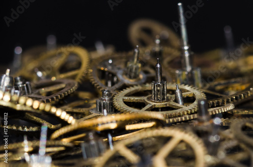 Watch Parts: Collection of Vintage Metallic Watch Gears on a Black Surface photo