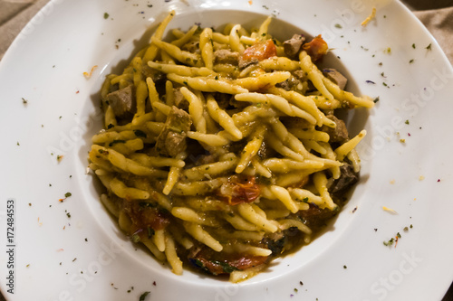 A dish of hand-made fusilli with tuna, Pachino tomatoes and parsley photo