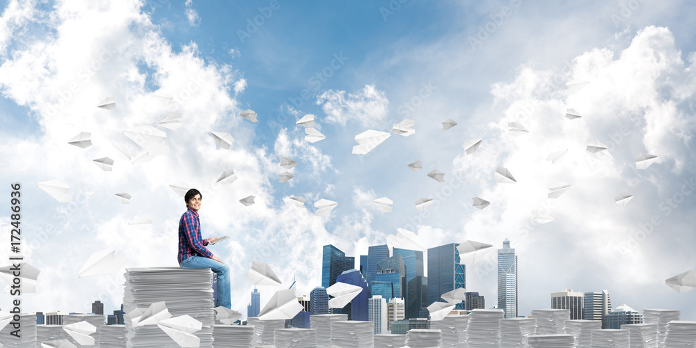 Attractive man sitting on pile of paper documents. Attractive man sitting on pile of paper documents.