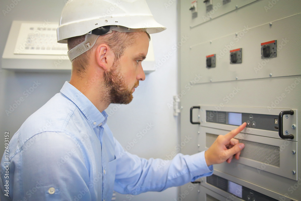electrical engineer for automation configures industrial controller.