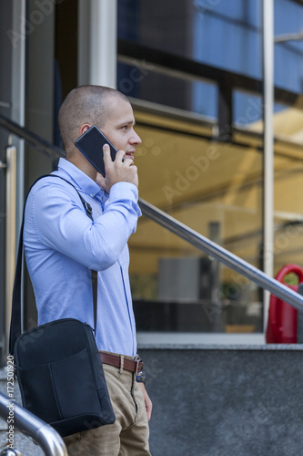 He talks to his business partners via a cell phone