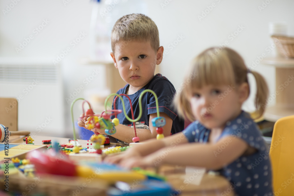 Cute brotker and sister in kindergarten looking at camera Cute brotker and sister in kindergarten looking at camera