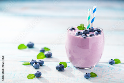 Bowl of blueberry   smoothie on wooden background