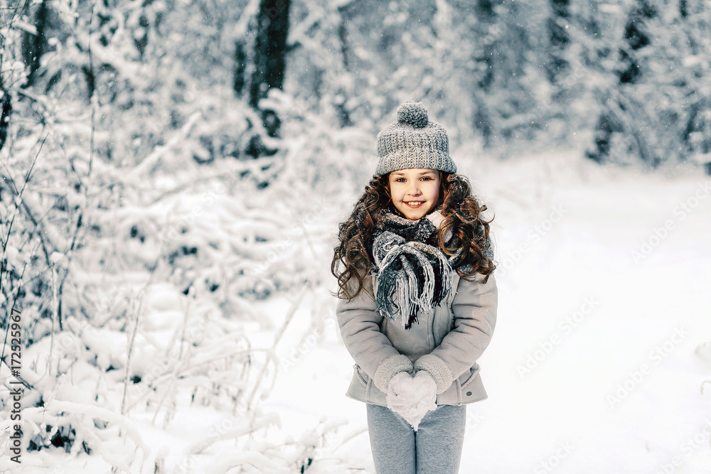 Children play outdoors in a snow-covered forest. Children play outdoors in a snow-covered forest.