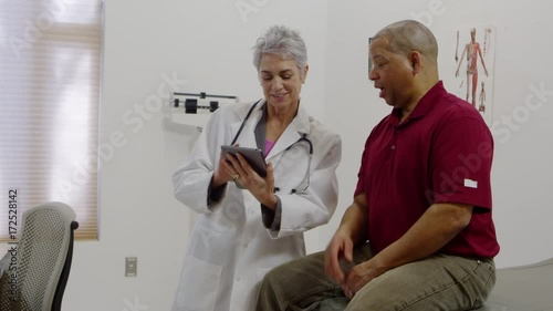 Patient talking to doctor and using a tablet
