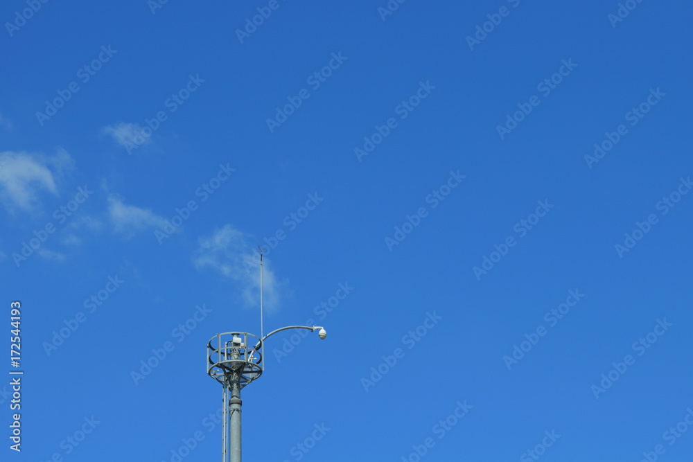 The radio tower under clear sky and white clouds The radio tower under clear sky and white clouds