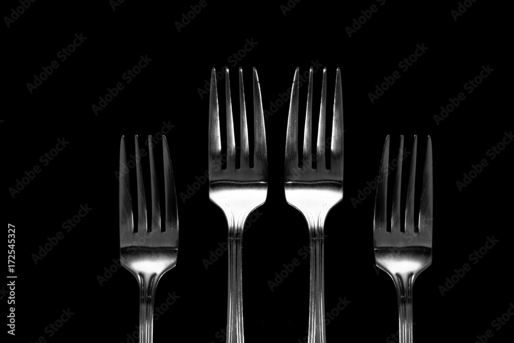 Fork background / A fork is a tool consisting of a handle with several narrow tines on one end Fork background / A fork is a tool consisting of a handle with several narrow tines on one end