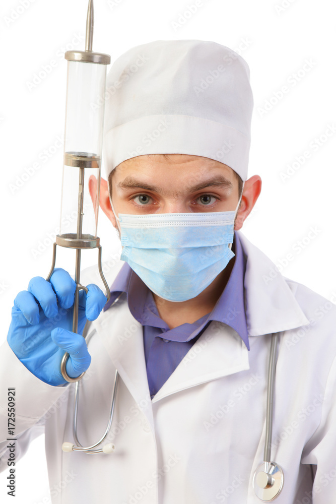 Portrait of the doctor in a mask with the big syringe isolated on a white background Portrait of the doctor in a mask with the big syringe isolated on a white background