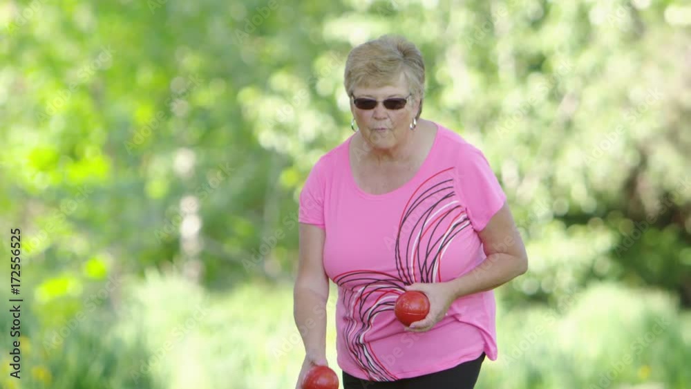 Elderly woman playing bocce ball Elderly woman playing bocce ball